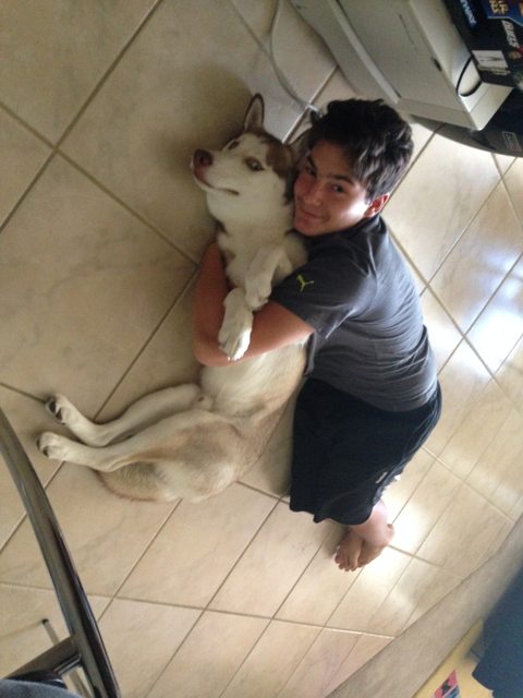 Apollo sharing a cuddle on the kitchen floor — 2014